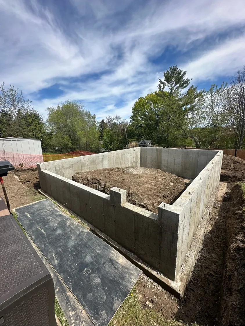 Poured concrete foundation walls within an excavated area